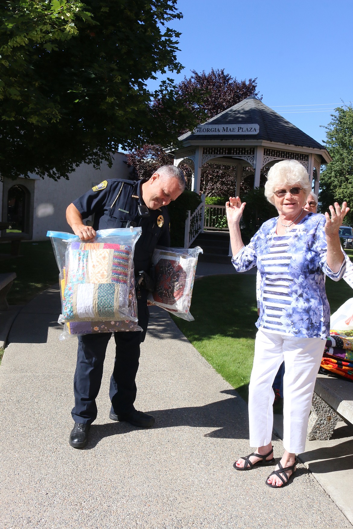 Photo by MANDI BATEMAN
Beverly Hokanson was pleased as the last of the quilts were handed out, and Bonners Ferry Police Chief Zimmerman admired them.
