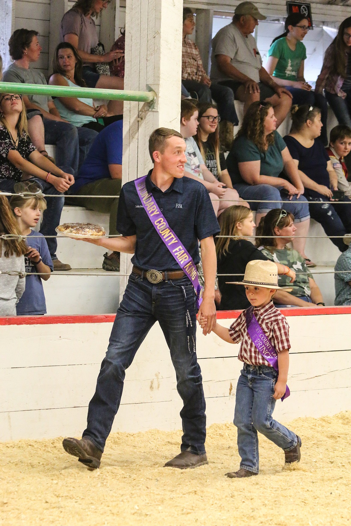 Photo by MANDI BATEMAN2018 Boundary County Fair King Caleb Petersen with 2019 Little Prince Leo Peterson, helping out with the bake sale.