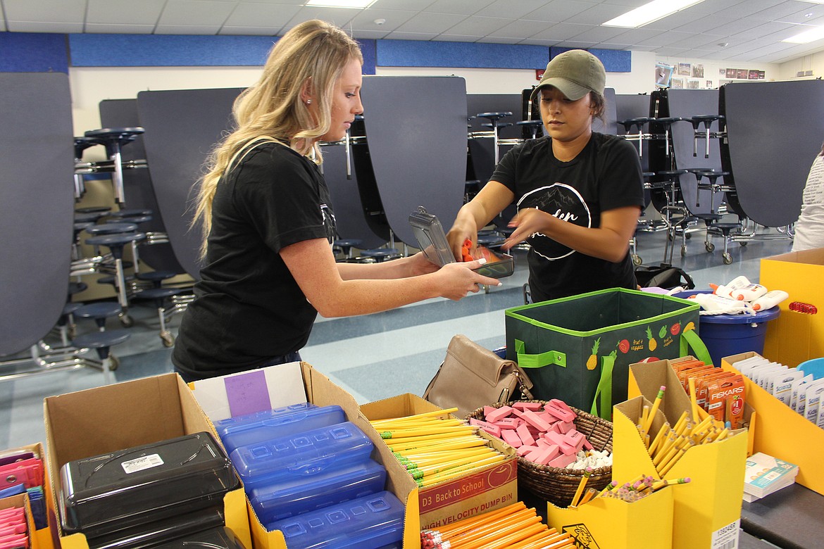 Cheryl Schweizer/For The Sun Tribune
Volunteers help pass out school supplies during Back 2 School last week in Warden.