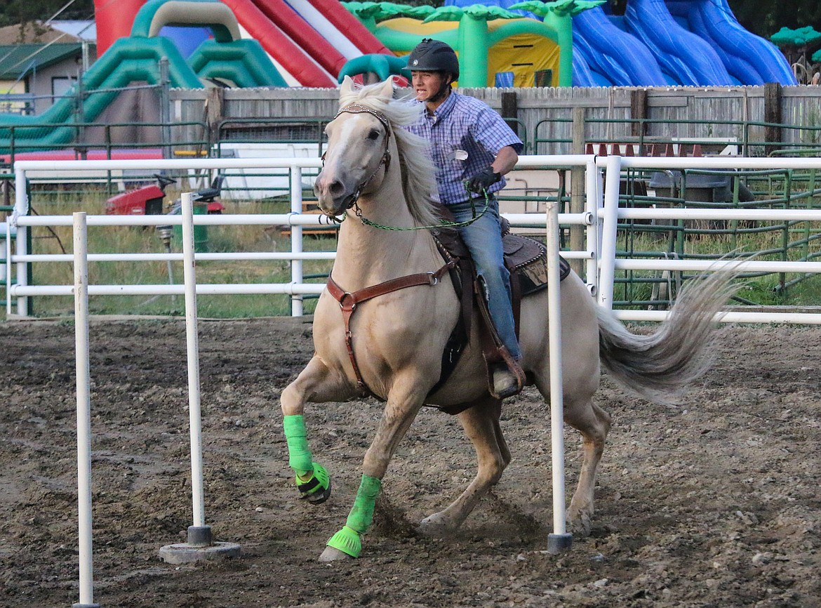 Photo by MANDI BATEMANThe keyhole race required horse and rider to race down and through the poles, then turn quickly and race back again.