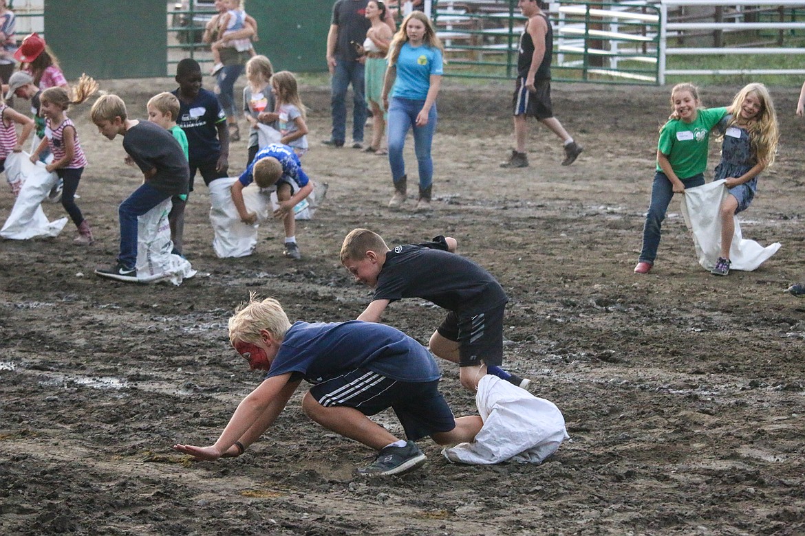 Photo by MANDI BATEMANDuring the three-legged race, the competitors tried to win and stay out of the mud.