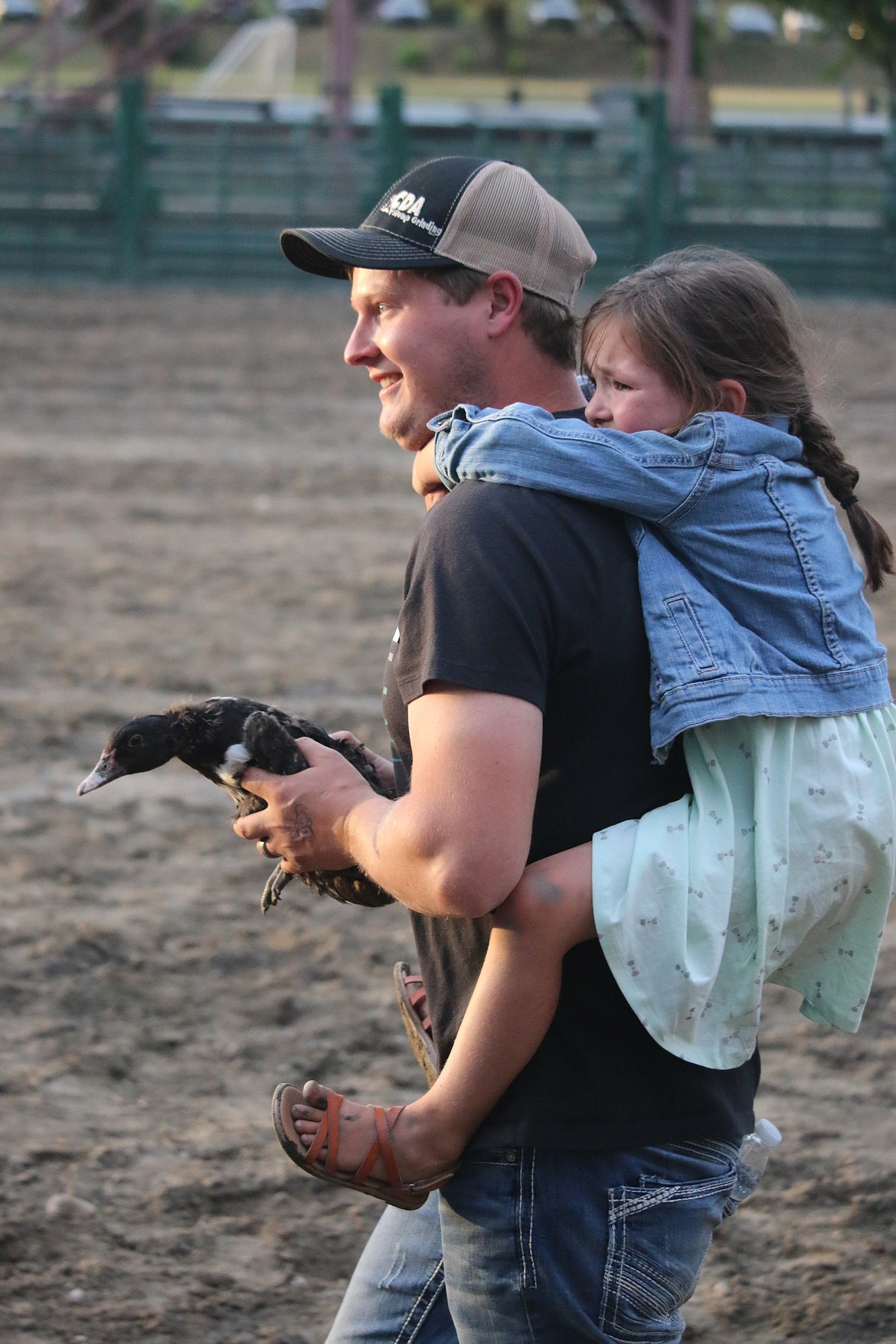 Photo by MANDI BATEMANA young girl gets a free ride after working hard to catch her duck.