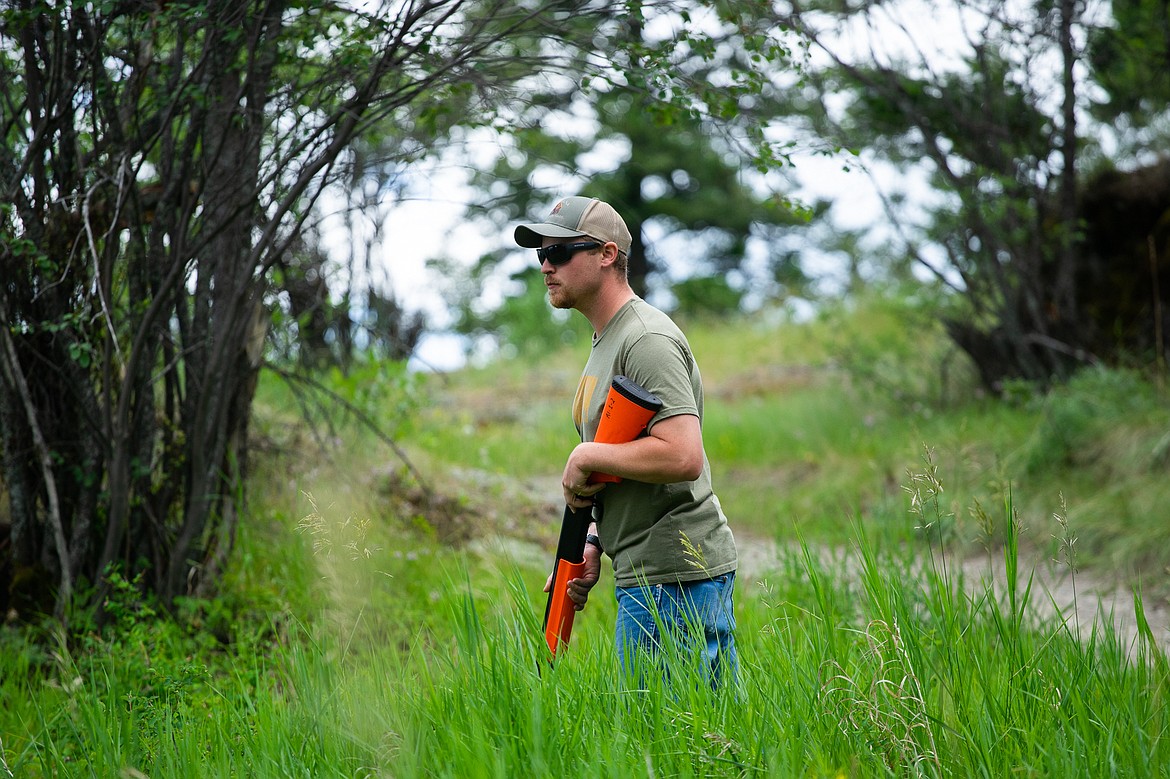 Region 1 Game Warden Chris Neu scans the brush for signs of an animal attack during a Montana Fish, Wildlife and Parks training program recently at Lone Pine State Park. (Daniel McKay/Whitefish Pilot)