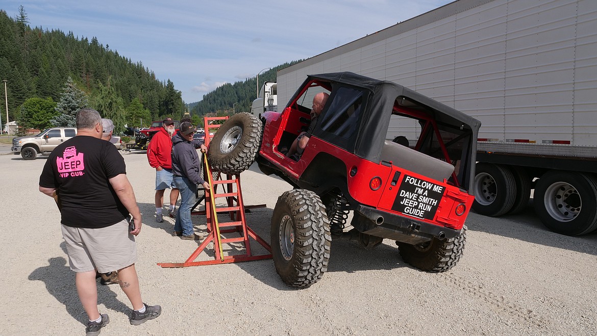 Photo by TODD THOMPSON
One of the many participants of the Jeep Obstacle Course drives his rig up onto the &#147;flex&#148; tester.