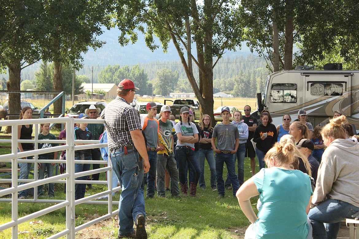RYAN BURK, the swine barn superintendant, on Saturday discusses what to expect next week with all the kids who entered pigs into the Sanders County Fair. (John Dowd/ Clark Frok Valley Press)