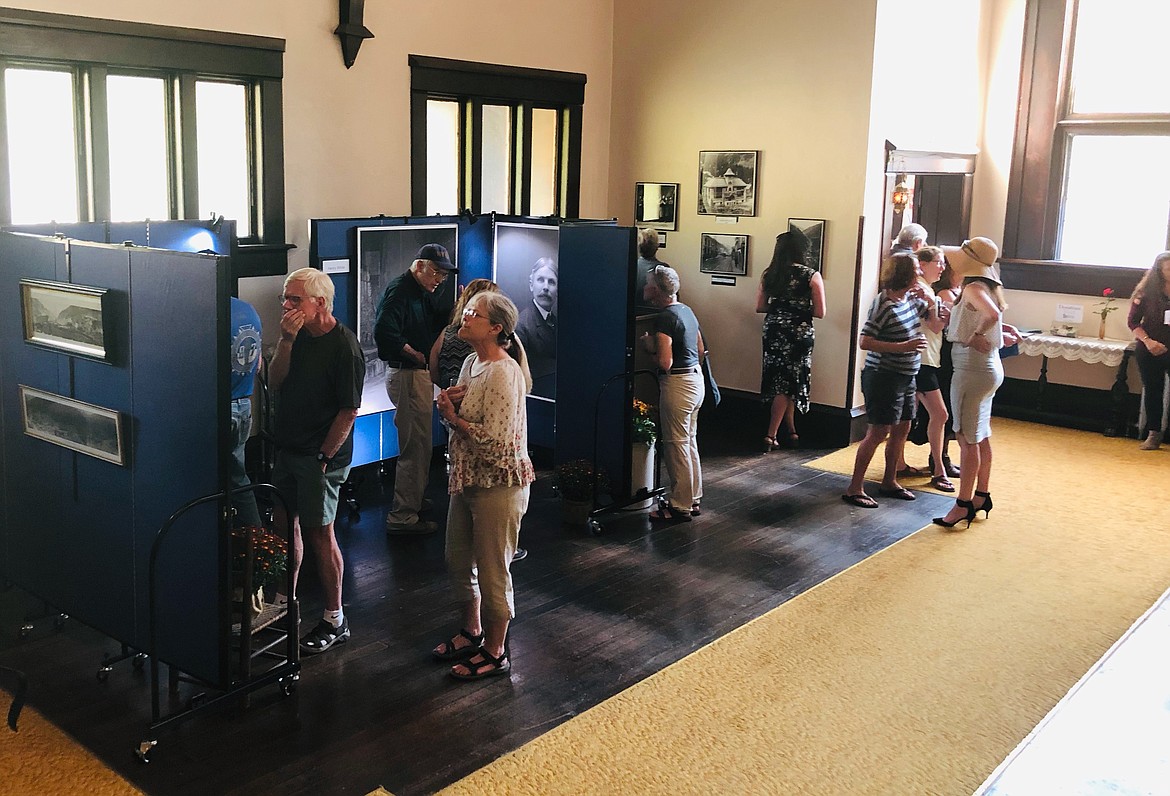 Photo by JOSH MCDONALD
Visitors at the Barnard-Stockbridge Museum wander through the photo displays inside the former Holy Trinity Episcopal Church in Wallace.