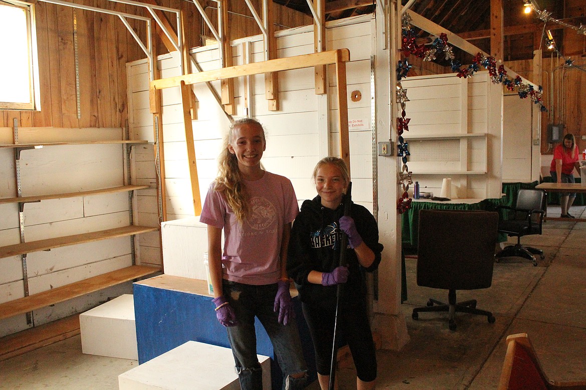 MCKENZIE ROBINSON and Trinity Riffle, both entered Photography projects into the Sanders County Fair for 4H. they were helping to clean the Home Economics barn before this weeks events. (John Dowd/ Clark Fork Valley Press)
