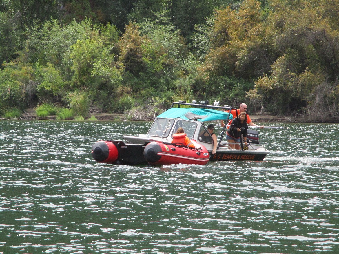 SCENARIO ROLE player in a raft as rescue boat circles and secures the raft. (Photo credit Shelly Rummell/ Clark Fork valley Press)