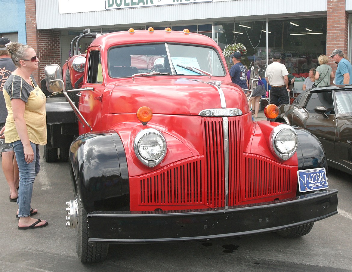 Stephanie Michalkiewicz looks over the &#145;48 M16 Studebaker flatbed belonging to Brian Weaver of Columbia Falls during Ignite the Nites car show Saturday. (Paul Sievers/The Western News)