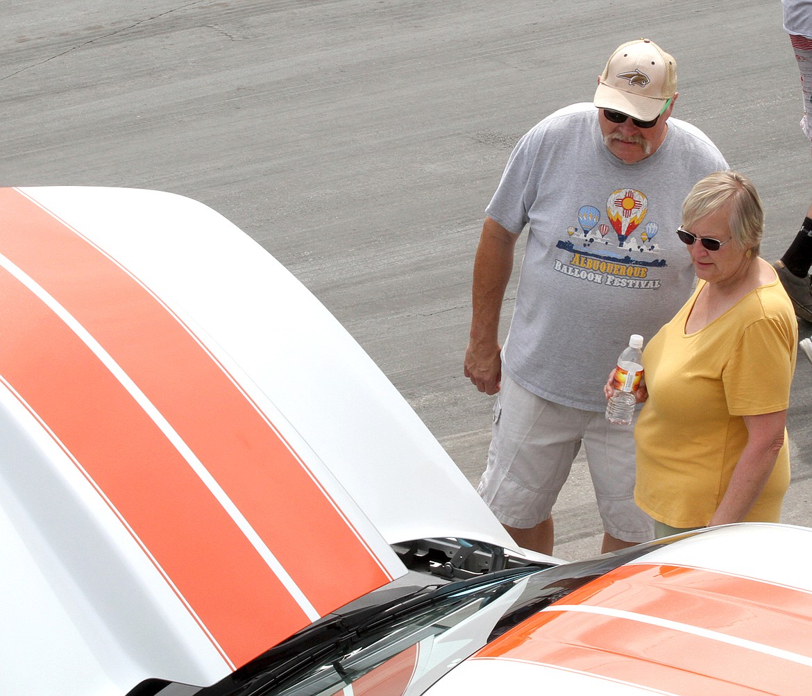 John and Barb Desch look over the '72 Z-28 Camaro belonging to Patrick Brotherton of Pinehurst, Idaho. (Paul Sievers/The Western News)