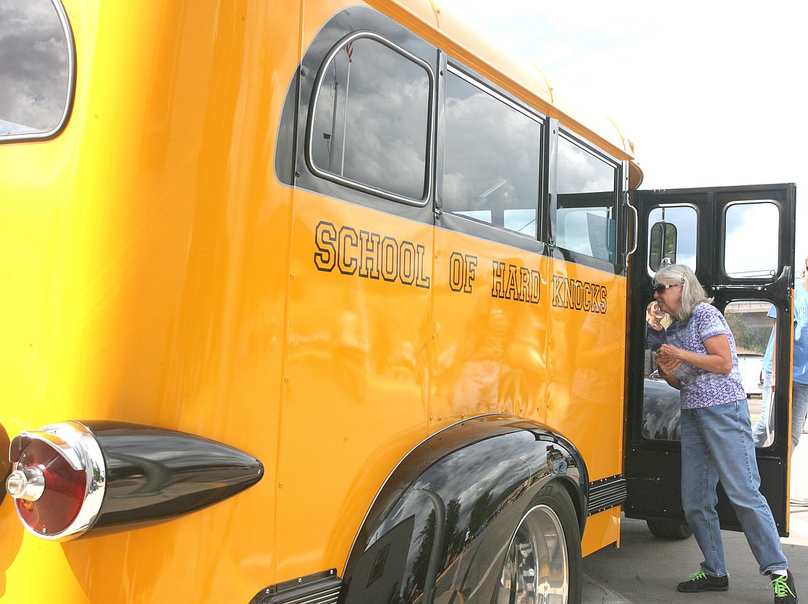 Eileen Vinion takes a peek inside the &#147;School of Hard Knocks&#148; &#145;41 Chevrolet school bus belonging to Curtis and Staci Ost of Whitefish. (Paul Sievers/The Western News)