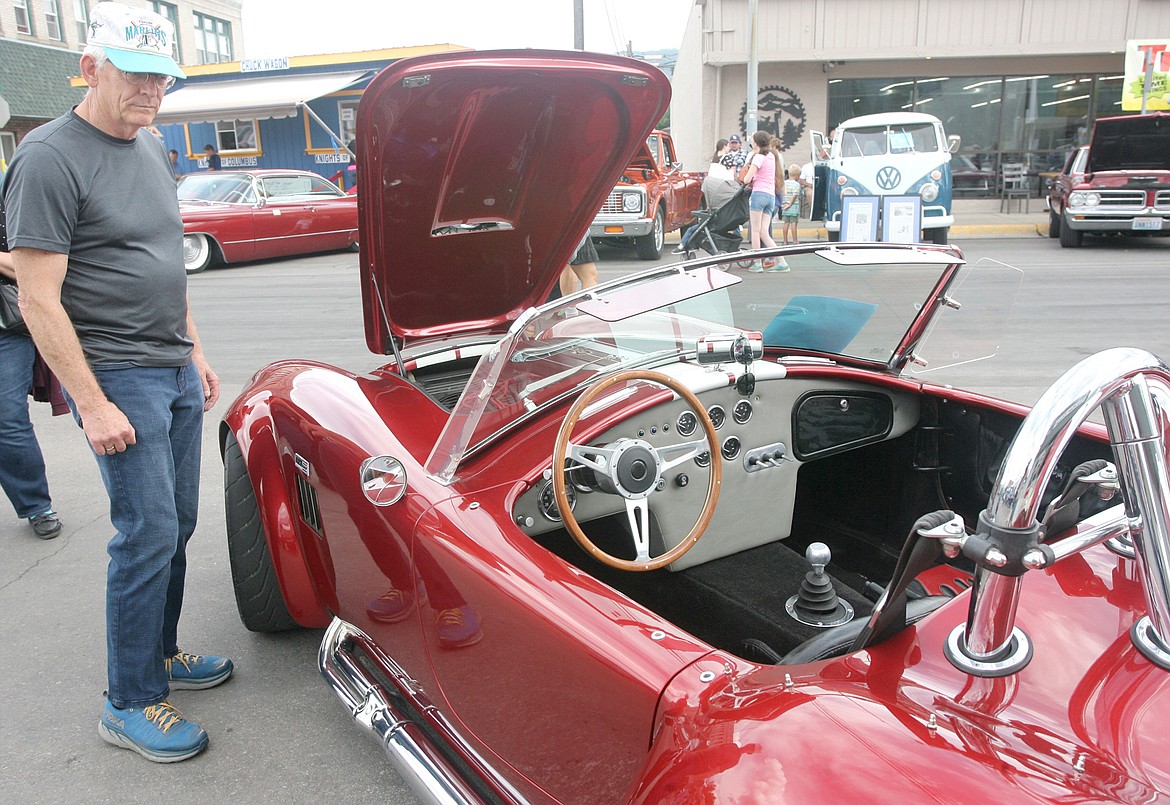 The '67 AC Cobra belonging to Dave Zuzero of Kalispell, caught this gentleman's eye during Saturday's Ignite the Nites car show. (Paul Sievers/The Western News)