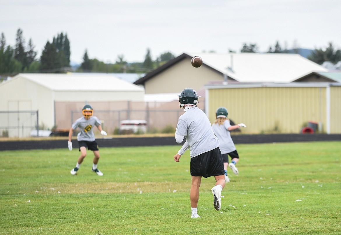 A trio of Bulldogs practice a passing play last Friday. (Daniel McKay/Whitefish Pilot)