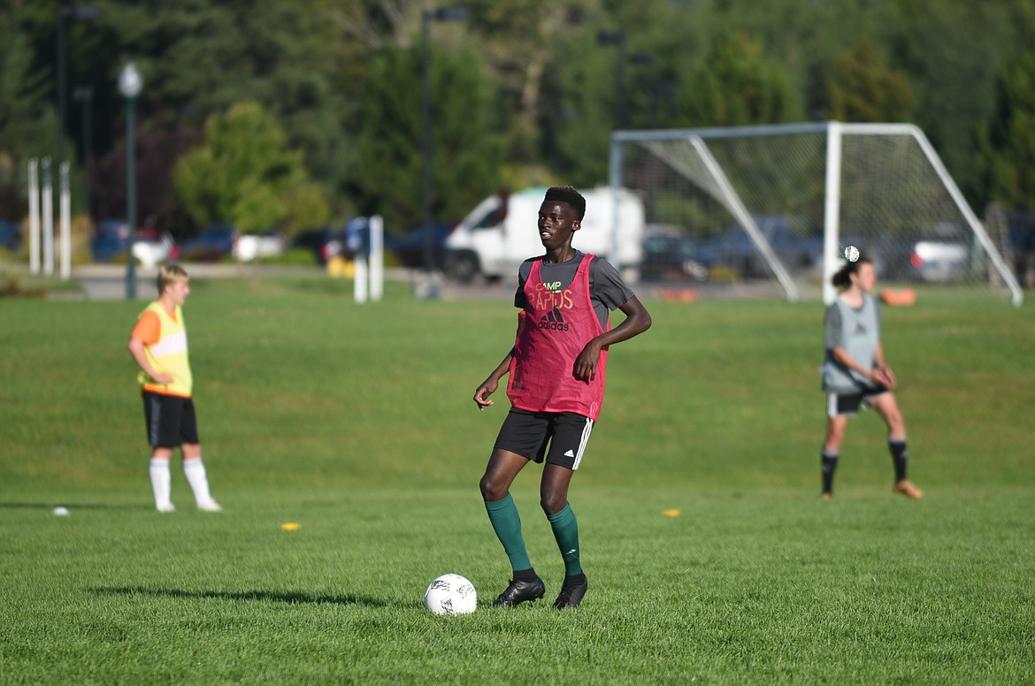 Marvin Kimera dribbles through a drill on Monday. (Daniel McKay/Whitefish Pilot)