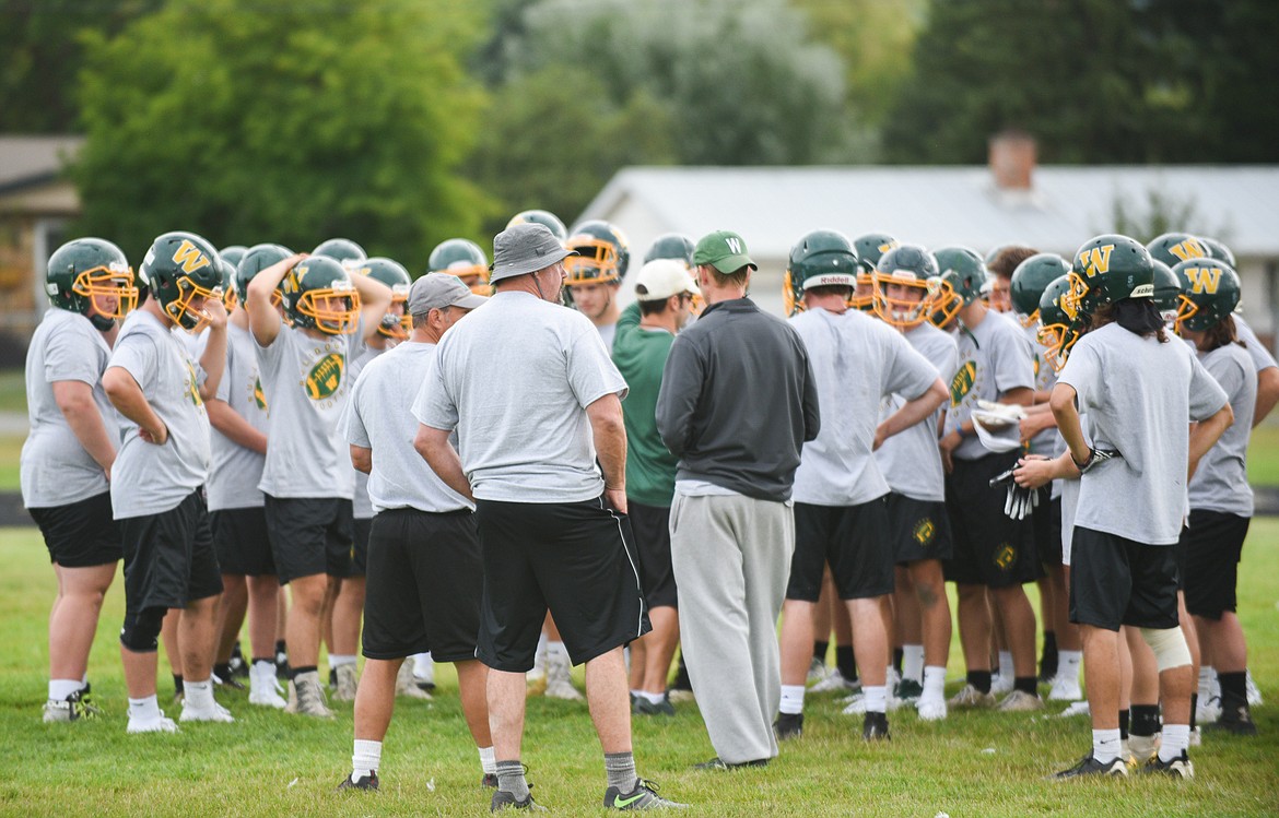 The Bulldogs football team huddles together at the end of the first day of practice on Friday, Aug. 16. (Daniel McKay/Whitefish Pilot)