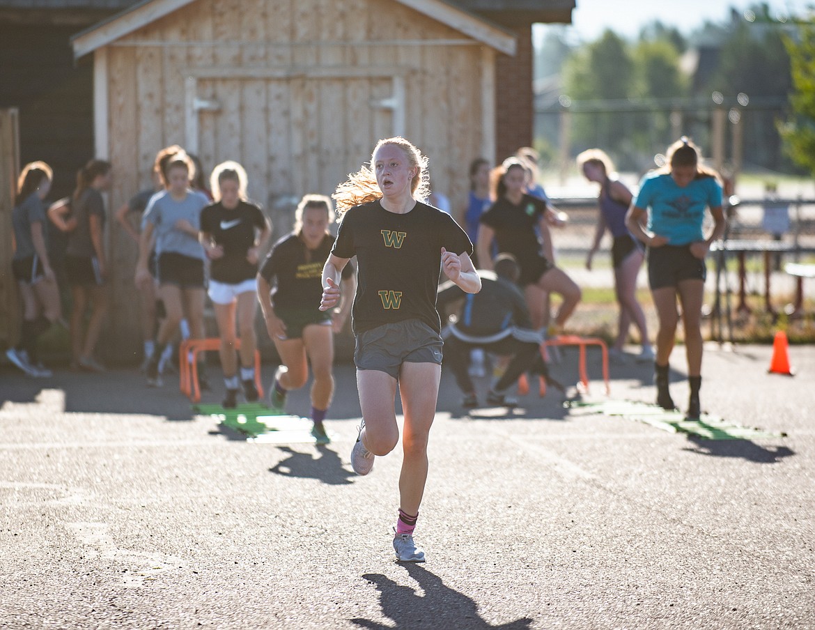 The Lady Dogs soccer team races through agility drills on Monday morning. (Daniel McKay/Whitefish Pilot)