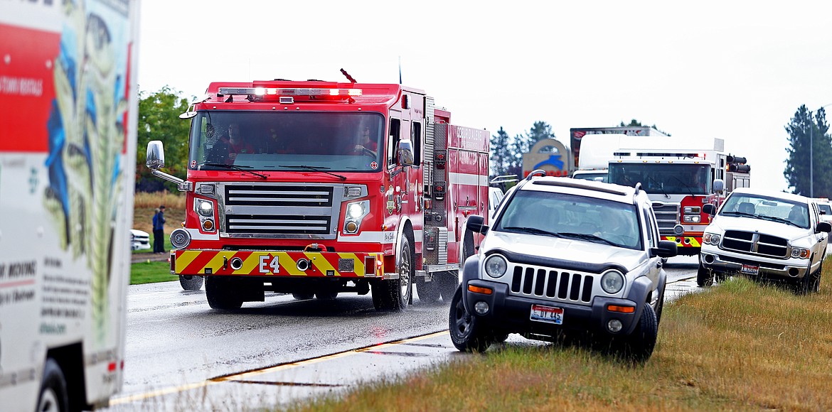 A Coeur d'Alene Fire Department engine makes its way north on U.S. 95 as part of the escort for Sgt. First Class Brian Sharp. (LOREN BENOIT/Press)