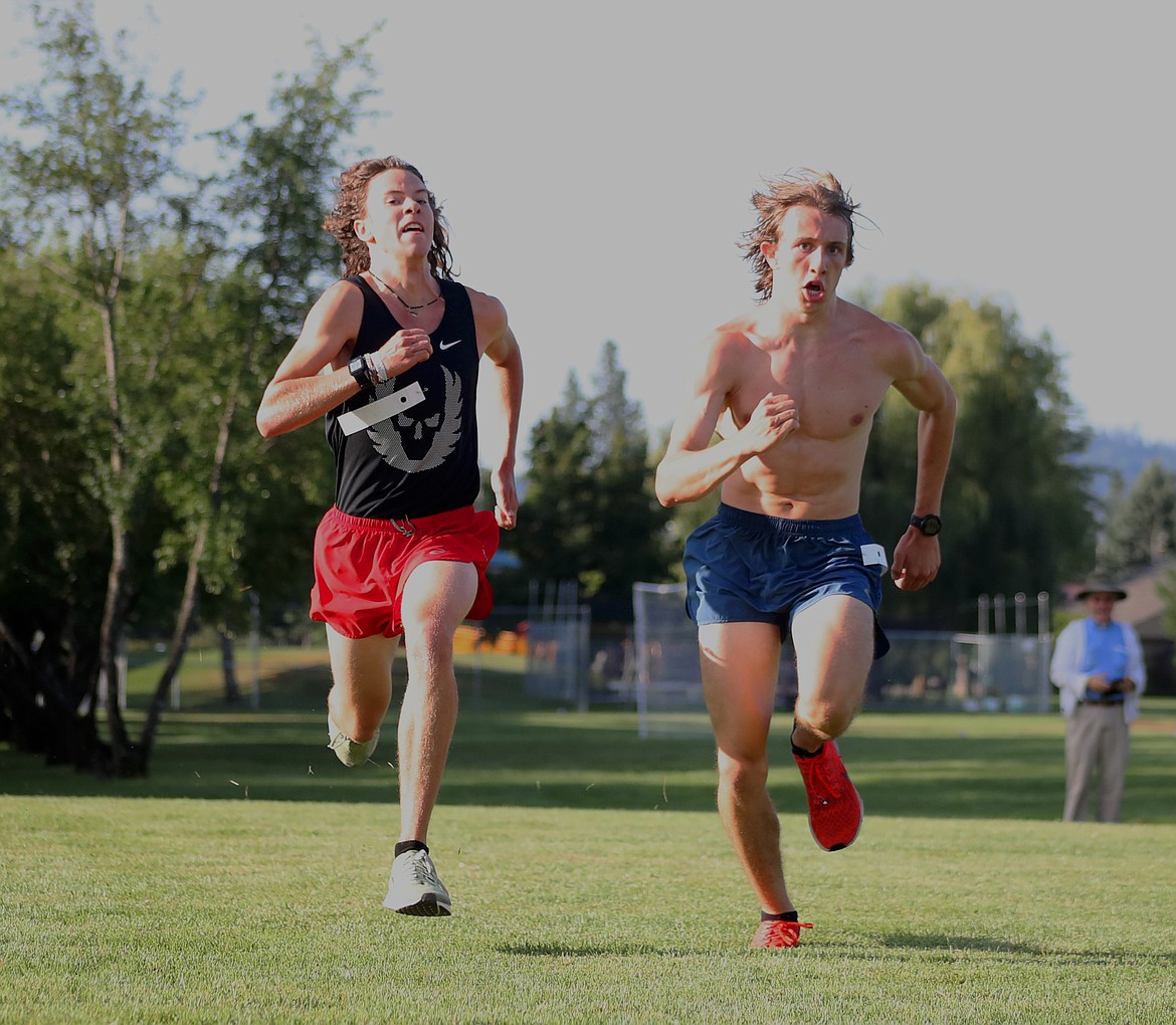 (Photo by KYLE CAJERO)Sandpoint junior Jett Lucas (left) and senior Gabe Christman (right) battle in the last 10 meters of the cross-country team&#146;s 5K time trial on Aug. 23.