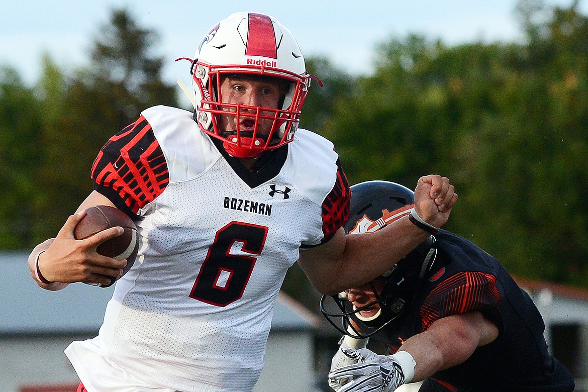 Bozeman quarterback Jack D'Agostino (6) eludes a Flathead defender on a first-quarter run at Legends Stadium on Friday. (Casey Kreider/Daily Inter Lake)