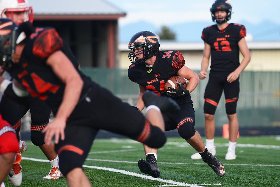 Flathead running back Drew Harrison (34) looks for a hole in the Bozeman defense in the first quarter at Legends Stadium on Friday. (Casey Kreider/Daily Inter Lake)