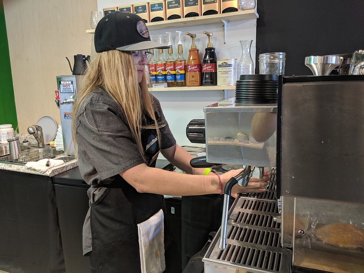 Ashley Wieser steams milk for an order on opening day. The shop also offers teas and small baked goods.