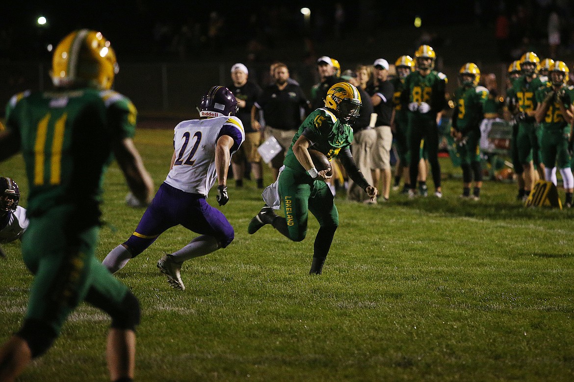 Lakeland quarterback Brandon Furey rushes upfield on a keeper during Friday night's game against Rogers. (LOREN BENOIT/Press)