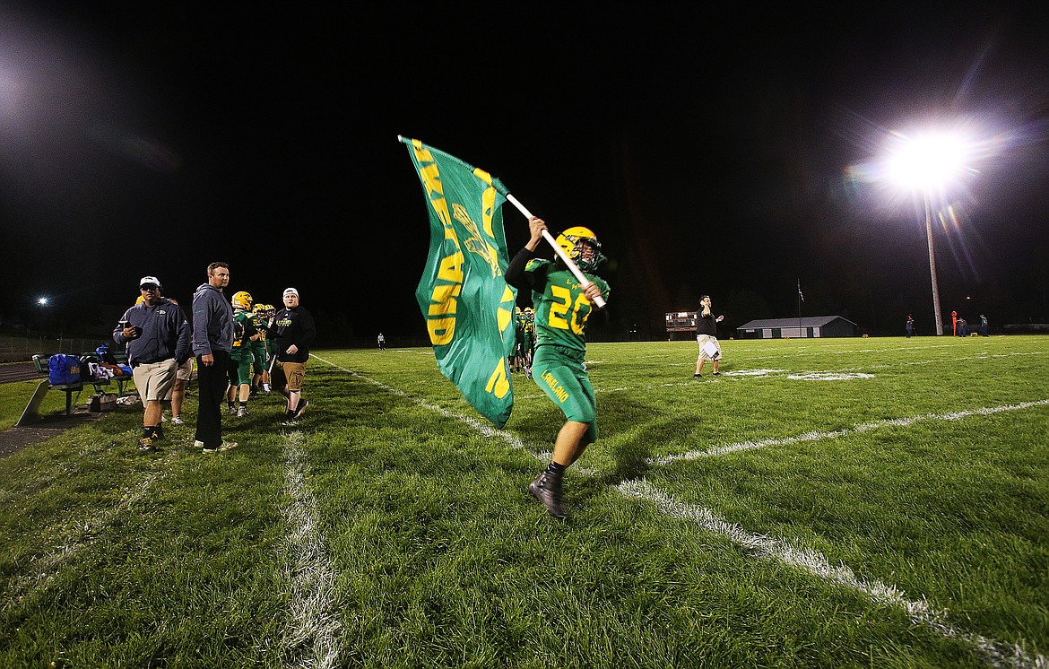 Lakeland&#146;s Riley Siegford waves the high school&#146;s flag before the start of the second half of Friday night&#146;s game against Rogers.