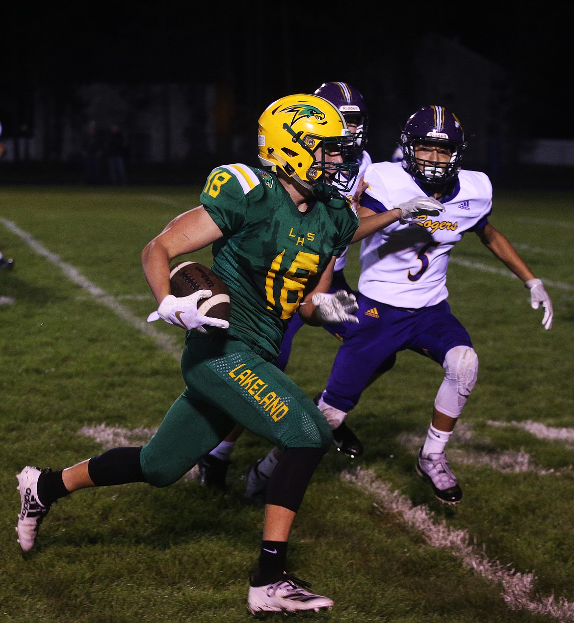 Lakeland wide receiver Harrison Kiefer catches the short pass and runs upfield against Rigby. (LOREN BENOIT/Press)