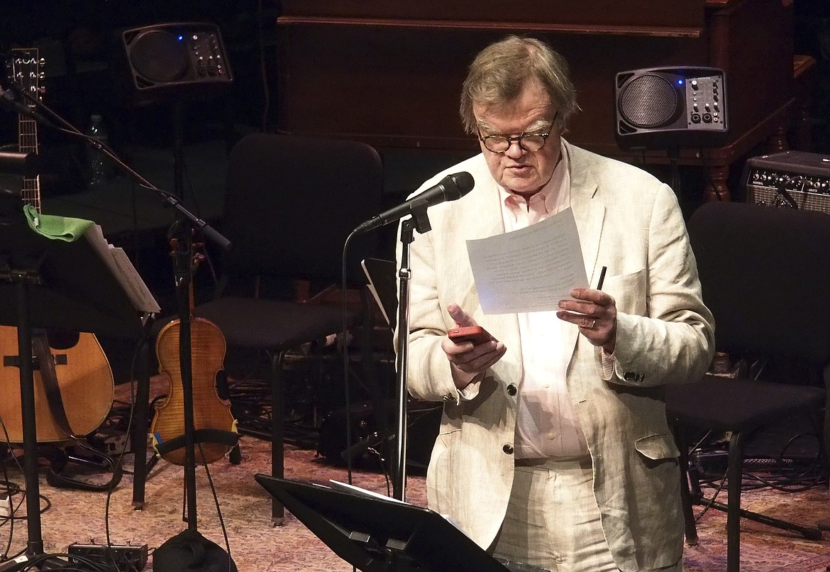 In this Feb. 19, 2016 photo, Garrison Keillor uses his phone at the Fitzgerald Theater in St. Paul to time a promo for an upcoming show. Keillor will perform in North Idaho College's Schuler Performing Arts Center with the Coeur d'Alene Symphony on Sept. 14. (Euan Kerr/Minnesota Public Radio via AP)