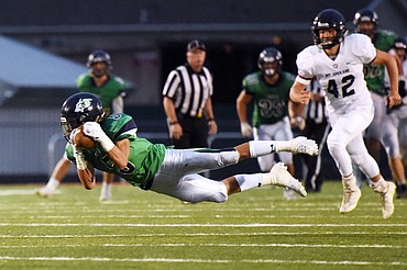 Glacier wide receiver Drew Deck (5) makes a diving reception in the third quarter against Mount Spokane at Legends Stadium on Friday. (Casey Kreider/Daily Inter Lake)