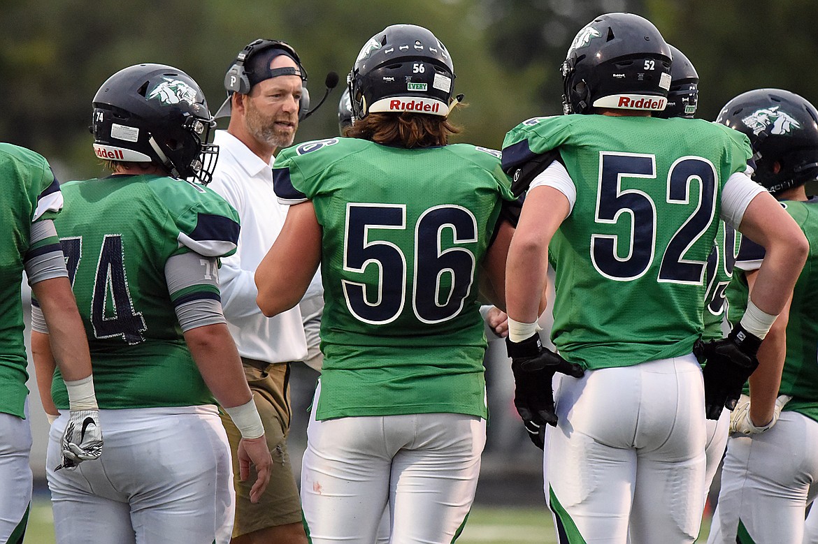 Glacier head coach Grady Bennett talks to the Wolfpack during a timeout in the first half against Mount Spokane at Legends Stadium on Friday. (Casey Kreider/Daily Inter Lake)