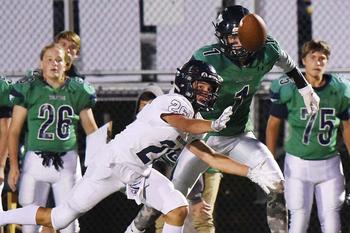 Glacier wide receiver Colin Bowden (1) and Mount Spokane defensive back Craig Runge (26) battle for a tipped pass in the third quarter at Legends Stadium on Friday. (Casey Kreider/Daily Inter Lake)