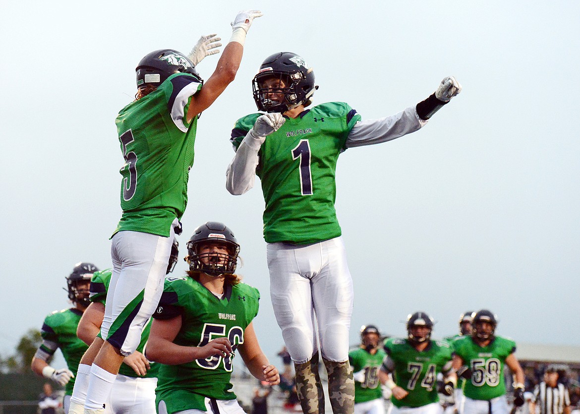 Glacier wide receivers Drew Deck (5) and Colin Bowden (1) celebrate after Deck's touchdown reception in the first half against Mount Spokane at Legends Stadium on Friday. (Casey Kreider/Daily Inter Lake)