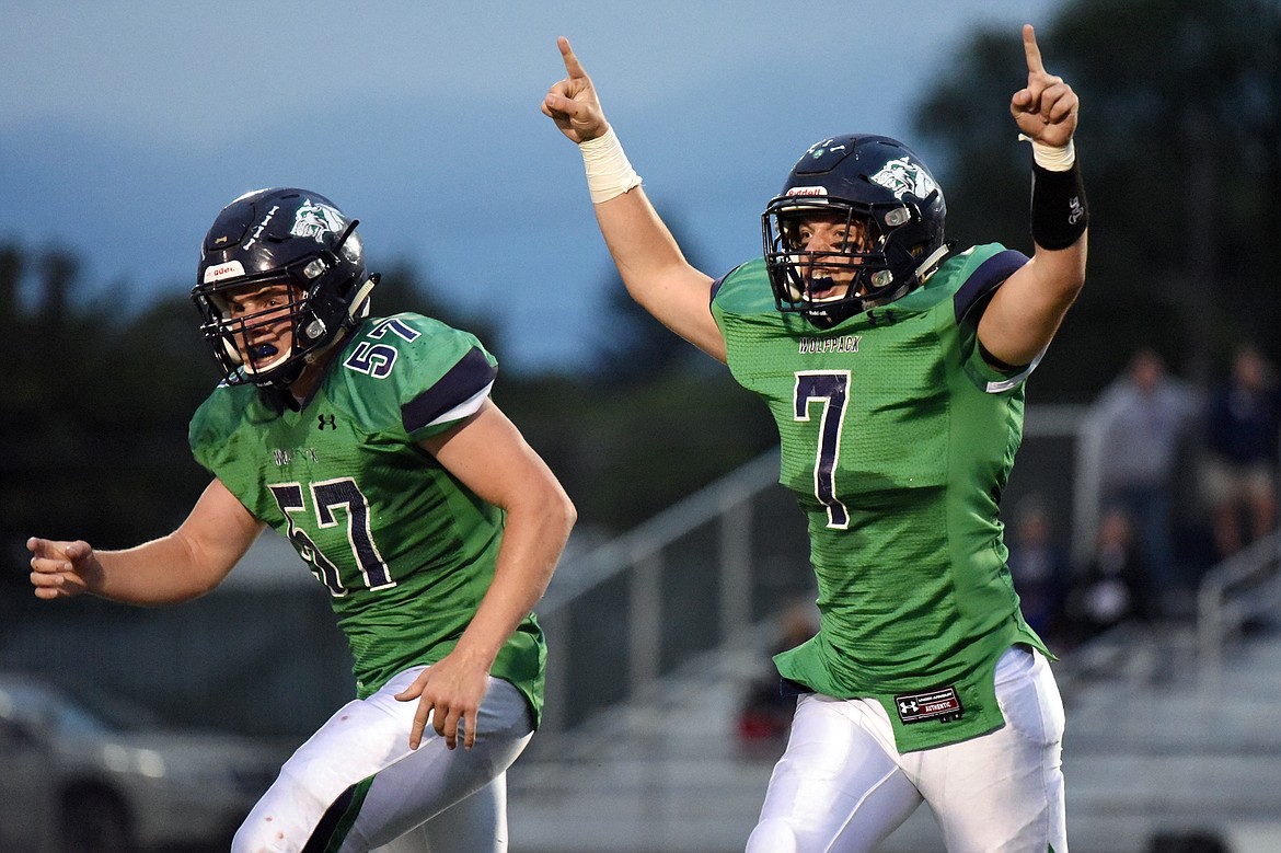 Glacier defenders Henry Nuce (57) and Ben Stotts (7) celebrate after the defense recovered a fumble in the second quarter against Mount Spokane at Legends Stadium on Friday. (Casey Kreider/Daily Inter Lake)