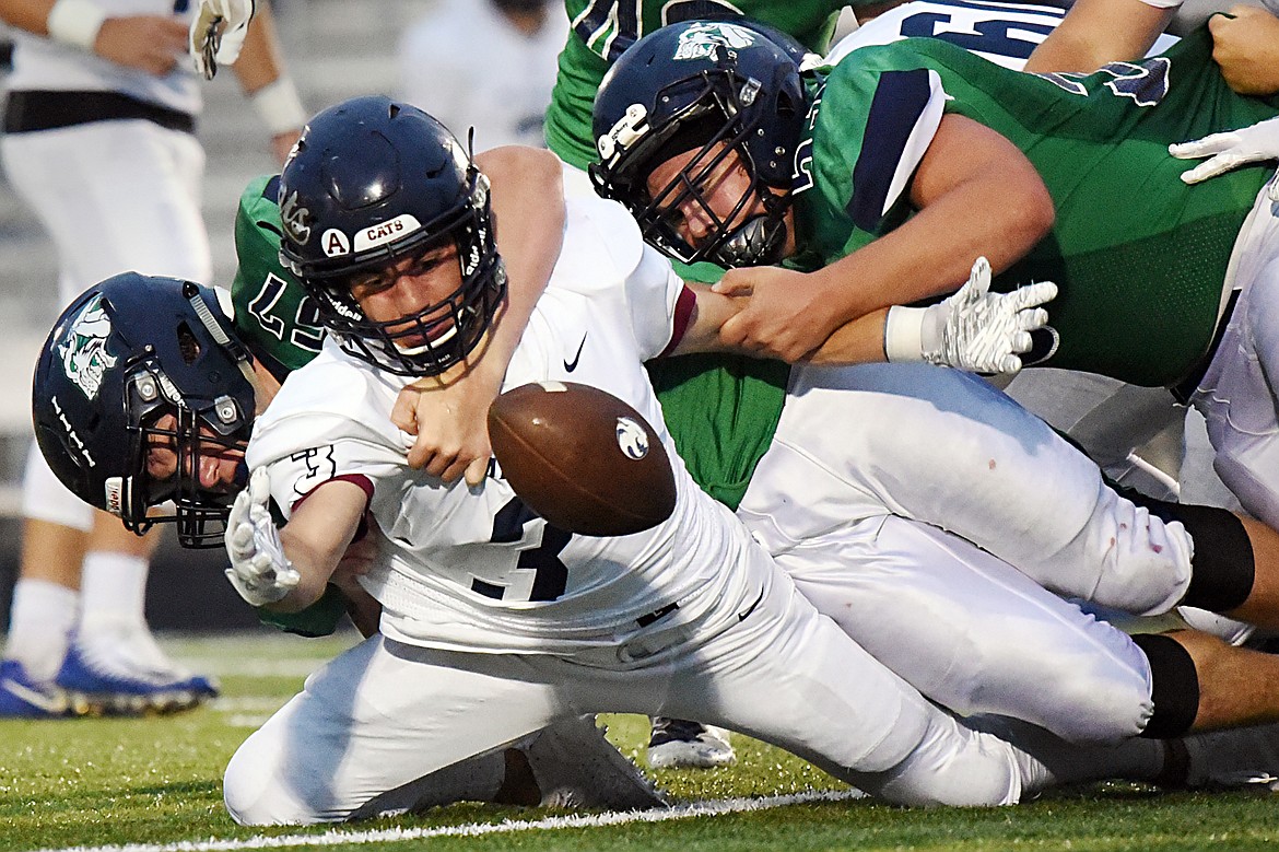 Glacier defenders Henry Nuce (57) and Justin Olson (53) force a fumble from Mount Spokane running back Connor Marll (3) in the second quarter at Legends Stadium on Friday. (Casey Kreider/Daily Inter Lake)