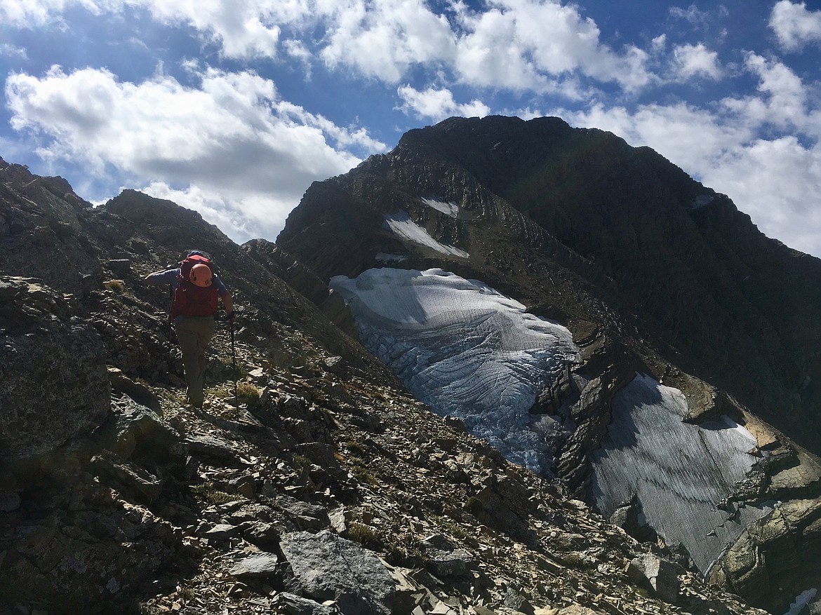 Rick Laverty climbs the summit ridge of Mount Jackson on Sept. 1 in Glacier National Park. A glacier still clings to the 10,000-foot mountain's north face. (Matt Baldwin/Daily Inter Lake)