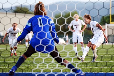 Flathead's Jalen Hawes (7) scores on a penalty kick past Glacier goalkeeper John Pyron (1) in the second half during crosstown soccer at Legends Stadium on Thursday. (Casey Kreider/Daily Inter Lake)