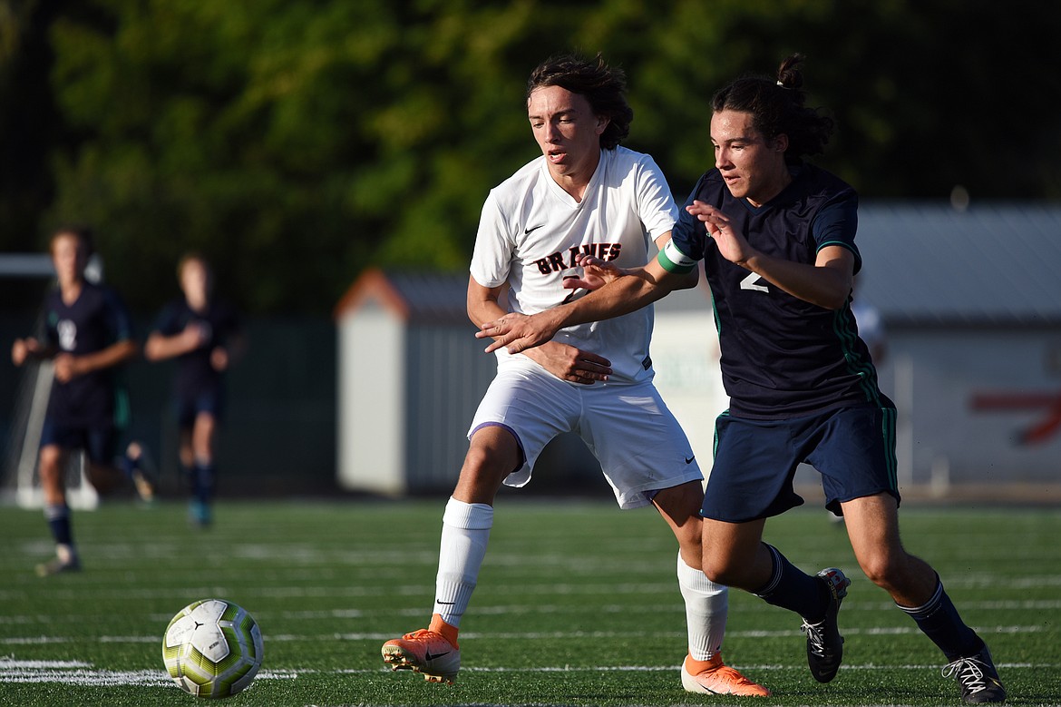 Flathead's Dakota Holmes (22) and Glacier's Diego Mendoza (2) battle for possession during crosstown soccer at Legends Stadium on Thursday. (Casey Kreider/Daily Inter Lake)