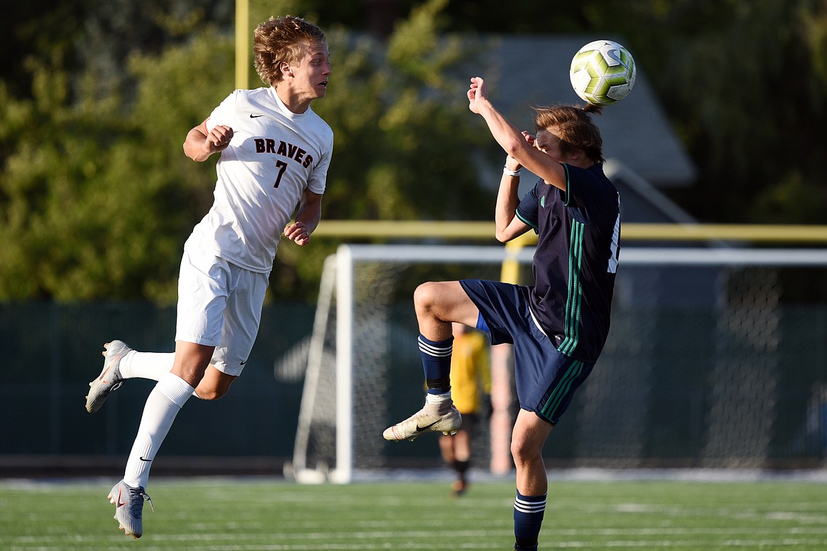 Flathead's Jalen Hawes (7) heads the ball past a Glacier defender during crosstown soccer at Legends Stadium on Thursday. (Casey Kreider/Daily Inter Lake)