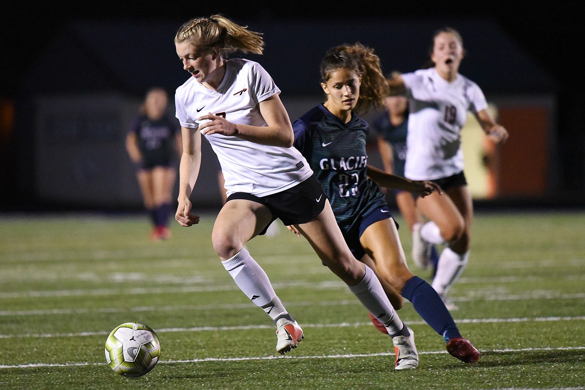 Flathead's Lily Tanko (7) is pursued by Glacier's Taylor Brisendine (23) during crosstown soccer at Legends Stadium on Thursday. (Casey Kreider/Daily Inter Lake)