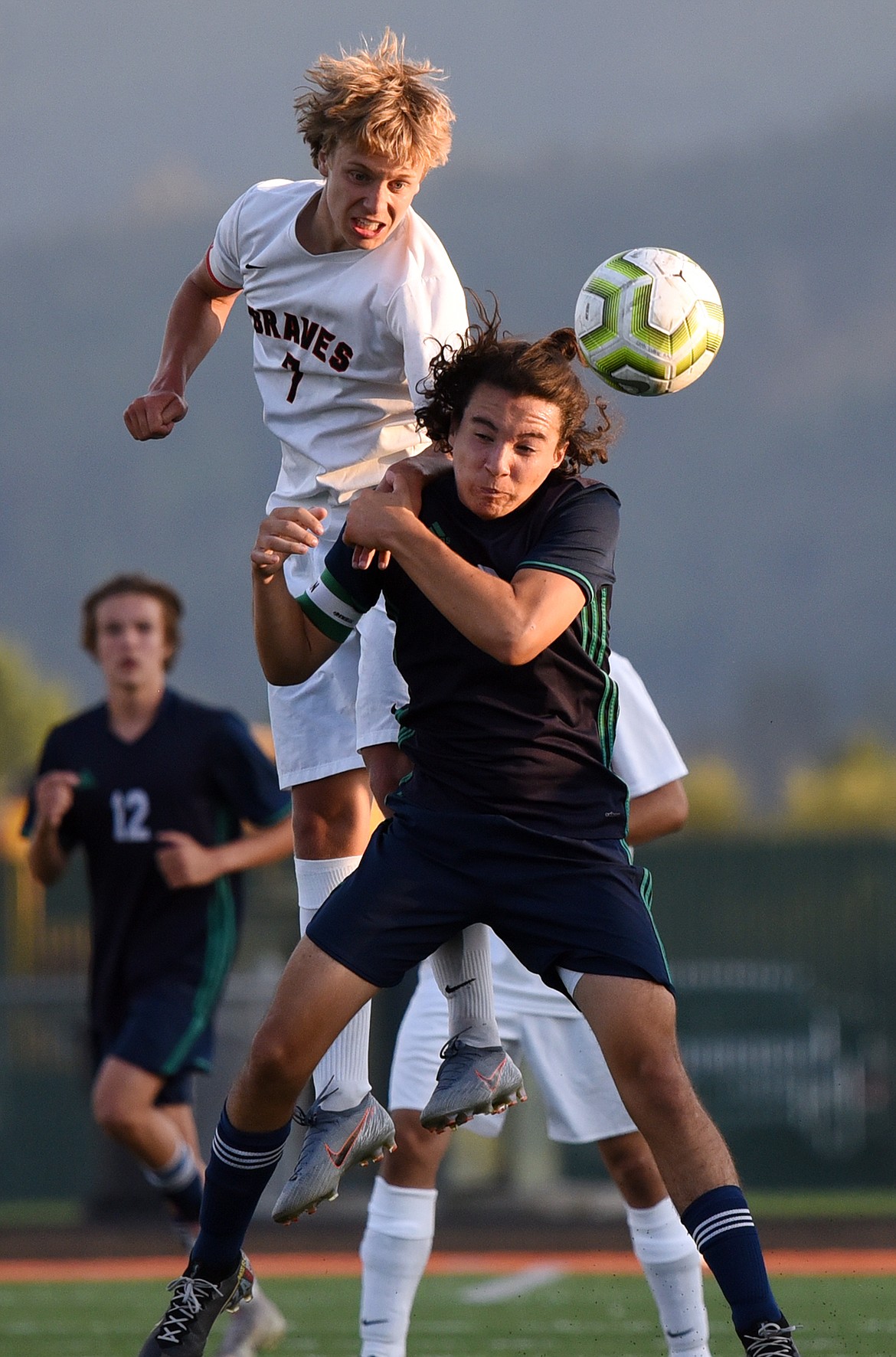 Flathead's Jalen Hawes (7) battles Glacier's Diego Mendoza (2) for a header in the second half during crosstown soccer at Legends Stadium on Thursday. (Casey Kreider/Daily Inter Lake)