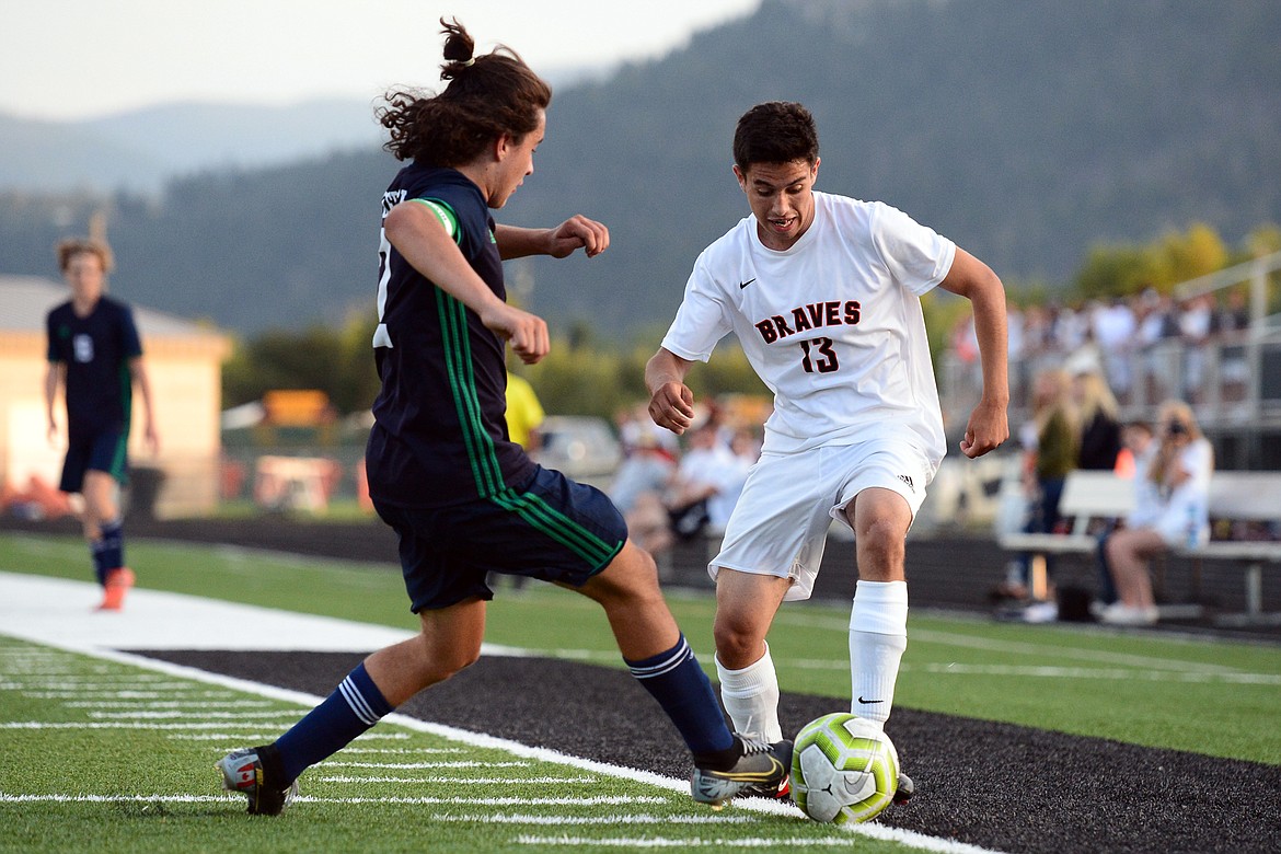 Flathead's Arsen Sokolov (13) controls the ball against Glacier's Diego Mendoza (2) during crosstown soccer at Legends Stadium on Thursday. (Casey Kreider/Daily Inter Lake)