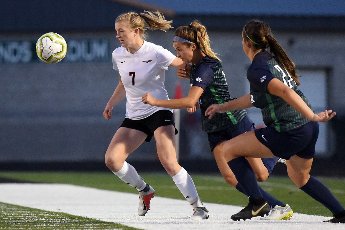 Flathead's Lily Tanko (7) keeps the ball away from Glacier's Alma Patrick (6) and Delanie Shultz (24) during crosstown soccer at Legends Stadium on Thursday. (Casey Kreider/Daily Inter Lake)