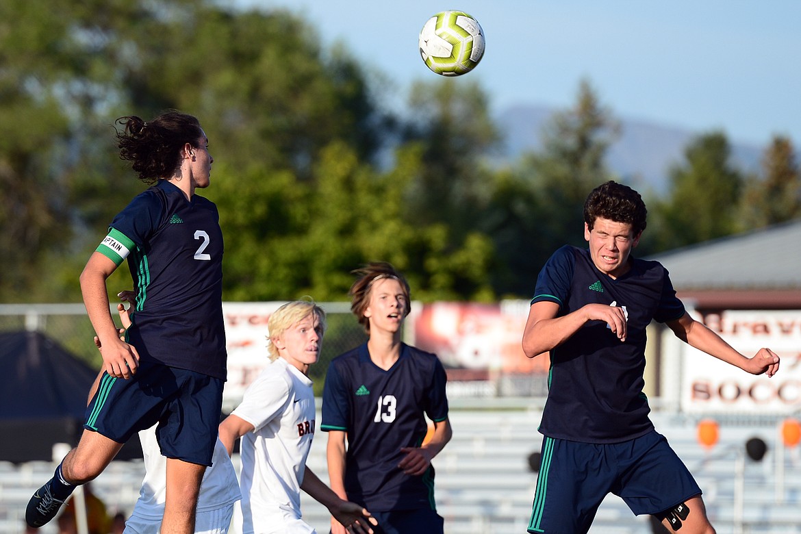 Glacier's Diego Mendoza (2) and Eli Mildren (14) head a Flathead corner kick out of the zone during crosstown soccer at Legends Stadium on Thursday. (Casey Kreider/Daily Inter Lake)