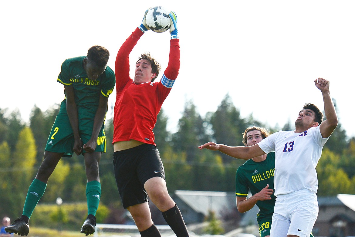 Columbia Falls goalkeeper Story Stemborski (1) makes a leaping save off a Whitefish corner kick as Bulldogs forward Marvin Kimera goes for a header at Smith Fields on Tuesday. (Casey Kreider/Daily Inter Lake)