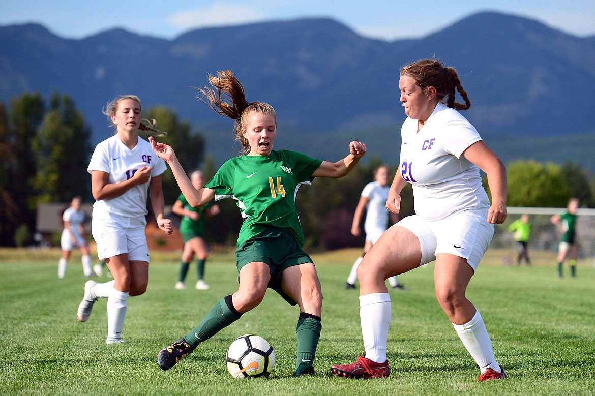 Whitefish's Josie Schneider (14) looks to shoot with Columbia Falls' Graceanne Sevesind (21) defending at Smith Fields on Tuesday. (Casey Kreider/Daily Inter Lake)
