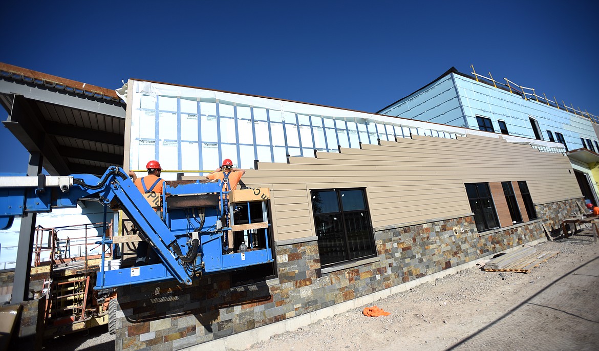 Martel Construction workers add siding to the exterior of the new Muldown Elementary on Aug. 28. The building is expected to be finished by June or July 2020 school year. (Brenda Ahearn/Daily Inter Lake)