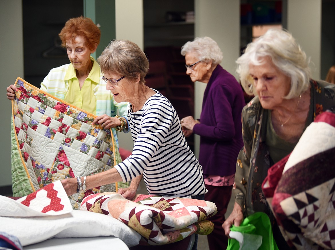 Members of the Tuesday Quilters Group gather around the various quilts they brought to their meet up at the First Presbyterian Church in Kalispell on Tuesday, Aug. 27. The members the who group are the featured quilter for the annual Flathead Quilt Show &#147;A Wee Bit Wooly&#148; Sept. 20 and 21 in the Expo Building of the Flathead County Fairgrounds. From left are Pat Linder, one of the original members, Pat Holder, Blanche Garrett and Adelyn Moss.
(Brenda Ahearn/Daily Inter Lake)