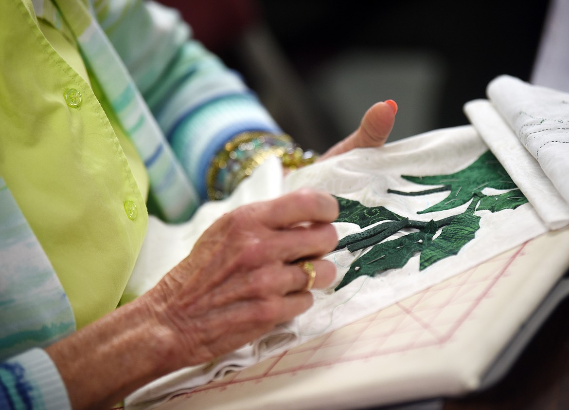 Pat Linder, one of the original members of the Tuesday Group, makes a quilt.