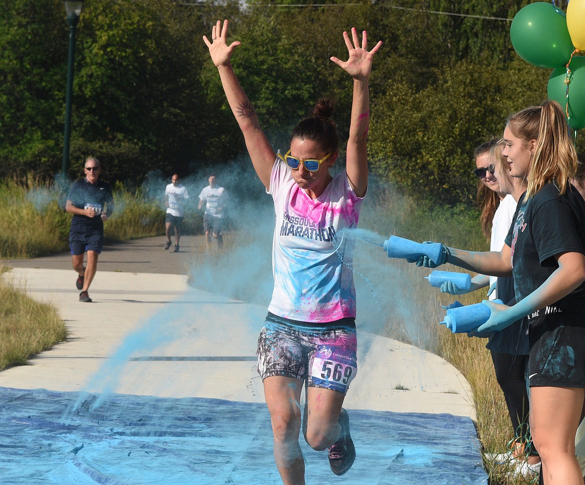 Camille Deitz gets splashed with blue Saturday morning during the Great Fish Community Challenge Color Run through Whitefish. (Heidi Desch/Whitefish Pilot)